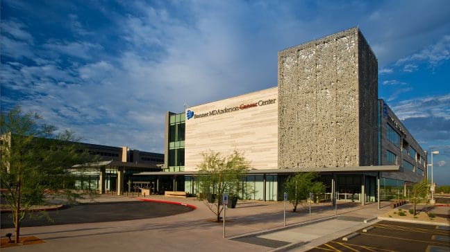 Modern medical center with a unique architectural design under a clear blue sky.