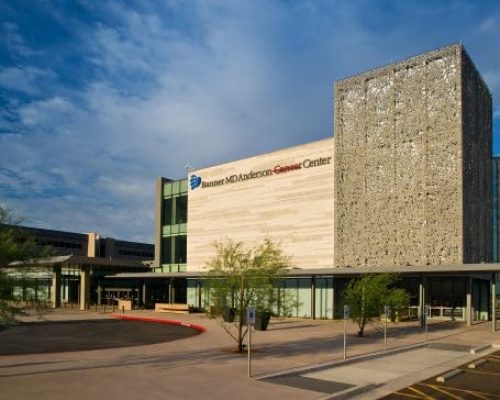 Modern medical center with a unique architectural design under a clear blue sky.