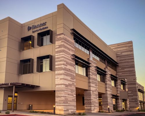 Modern medical facility at dusk with clear skies and no visible activity.